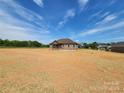 New construction home featuring a brick facade under a blue sky and ample yard space awaiting landscaping at 3251 Wilson Ct # 10, Lincolnton, NC 28092