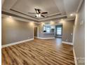 An open concept living space boasts beautiful trey ceiling, recessed lighting, and wood-look flooring at 3251 Wilson Ct # 10, Lincolnton, NC 28092