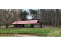 Rustic wooden structure with red metal roof by a pond at 12505 Old Beatty Ford Rd, Rockwell, NC 28138