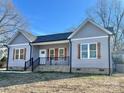 Newly constructed home with gray siding and a neat lawn at 325 Jordan Ave, Spencer, NC 28159