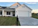 Newly constructed home with board and batten siding, a mailbox, and an attached two-car garage at 120-C Deer Brook Dr, Shelby, NC 28150