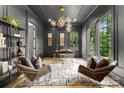 Sophisticated office space with paneled walls, a stylish light fixture, large windows and wood flooring at 4142 Pineview Rd, Charlotte, NC 28211