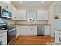 Modern kitchen with white cabinets, granite counters, and stainless steel appliances at 2165 Smith Rd # 9, Clover, SC 29710