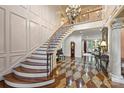 Grand foyer with staircase, chandelier, and decorative tile floor at 525 Lake Lynn Rd, Concord, NC 28025