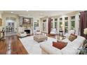 Bright living room featuring a stone fireplace, hardwood floors, and large windows with natural light at 525 Lake Lynn Rd, Concord, NC 28025