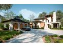 Stunning modern home with a detached garage, a manicured lawn, and a circular driveway at 8022 Litaker Manor Ct, Charlotte, NC 28270