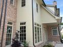 Elegant view of the home showcasing a blend of brick and siding, complemented by large windows and refined architectural details at 1969 Maryland Ave, Charlotte, NC 28209