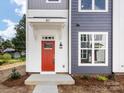 Red front door entryway with white trim and a covered porch at 2125 Acclaim St, Charlotte, NC 28205