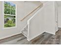 Modern staircase with a wooden handrail and carpeted steps at 2129 Acclaim St, Charlotte, NC 28205