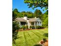 Charming home featuring well-maintained lawn, lush landscaping, and a classic architectural style at 796 Cornelius Rd, Mooresville, NC 28117
