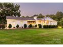Inviting home with a lush green lawn, elegant facade, and an American flag flying at 796 Cornelius Rd, Mooresville, NC 28117