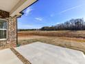 A concrete patio with a brick border offers a peaceful outdoor space with serene nature views at 1108 Piper Meadows Dr # 52, Waxhaw, NC 28173