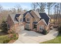 Stunning brick home with a large driveway and attached garage on a sunny day at 2012 Tomshire Dr, Gastonia, NC 28056