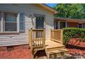 Wooden deck and steps leading to the front entrance of the home at 1571 Branchville Rd, Shelby, NC 28150