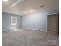 Spacious living room with gray walls and gray carpeting at 1571 Branchville Rd, Shelby, NC 28150