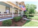 Inviting porch view showcasing the landscaped yard and mature foliage at 235 Walnut St, Statesville, NC 28677