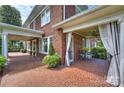 Spacious covered porch with brick flooring at 215 N Main St, Belmont, NC 28012