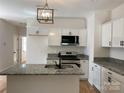 Modern kitchen with granite countertops, stainless steel appliances, and a stylish island sink at 814 W Raleigh W Ave, Statesville, NC 28677
