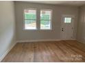 Sun-filled room with new hardwood floors, white walls, and windows with views to the yard at 814 W Raleigh W Ave, Statesville, NC 28677