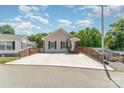 Cozy single-story home featuring a welcoming front porch and a large concrete driveway for ample parking at 159 Badin Lake Cir, New London, NC 28127