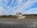 Two story farmhouse with white siding and a wraparound porch at 1145 Philbeck Rd # 11, York, SC 29745