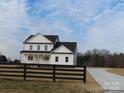 Two-story farmhouse with white siding, black accents, and a front porch at 1187 Philbeck Rd # 13, York, SC 29745