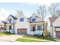 A charming two-story home featuring modern architecture, white siding, dark window frames, and well-maintained landscaping at 3945 Plainview Rd, Charlotte, NC 28208