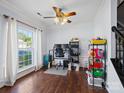 Office with wood floors, ceiling fan, and a large window allowing natural light at 5535 Whispering Wind Ln, Indian Trail, NC 28079