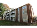 Back of condo building, showcasing brick and siding at 1645 Arlyn Cir # J, Charlotte, NC 28213