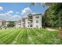 Condo building with pool and manicured lawn at 17810 Half Moon Ln # Q, Cornelius, NC 28031