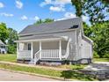 Gray house with a white porch, landscaping, and a spacious yard at 37 Knox St, Salisbury, NC 28144