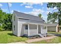 Newly renovated house with gray siding, white porch, and landscaped yard at 37 Knox St, Salisbury, NC 28144