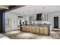 Gourmet kitchen featuring a large island, modern appliances, and stylish pendant lighting at 4658 Sugar Plum Ln, Davidson, NC 28036