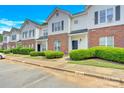 Two story brick and white townhome with landscaping and parking at 6436 Mallard View Ln, Charlotte, NC 28269