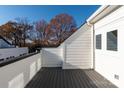 A rooftop deck offers a peaceful outdoor space with gray composite decking and white railings at 1409 Collier Walk Aly # Csw0104, Charlotte, NC 28205