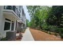Modern townhome featuring a sidewalk, landscaped mulch bed, and partial brick facade at 1413 Collier Walk Aly # Csw0106, Charlotte, NC 28205