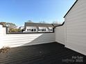 Outdoor deck featuring wood-look flooring, white railings, and a view of the neighborhood, ideal for relaxation and entertaining at 1211 E 34Th St # Csw0313, Charlotte, NC 28205