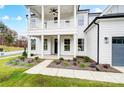 Inviting front porch with white columns, railing and manicured landscaping at 2003 Cedar Falls Dr # 69, Waxhaw, NC 28173