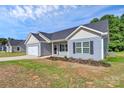 Beautiful blue single-story home with a two-car garage and well-maintained lawn under a sunny, partly cloudy sky at 6122 Lowder Rd, Salisbury, NC 28147