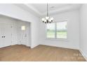 Inviting dining room with natural light and wood-look floors, complemented by an elegant chandelier at 6154 Lowder Rd, Salisbury, NC 28147