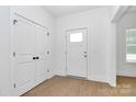 Bright entryway with wood-look flooring, closet for storage, and door with window at 6154 Lowder Rd, Salisbury, NC 28147