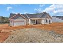 New construction featuring a large attached garage and covered entryway, surrounded by a raw landscape at 6154 Lowder Rd, Salisbury, NC 28147