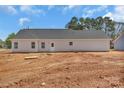 New construction featuring a simple rear exterior with minimal landscaping and a view of the tree line at 6154 Lowder Rd, Salisbury, NC 28147