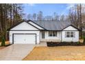 Charming single-story home with a well-maintained yard and attached garage in a quiet neighborhood at 6160 Lowder Rd, Salisbury, NC 28147
