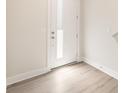 Entryway with white door with sidelight, light walls, and durable laminate flooring at 320 Ferebee Pl # Brx0021, Charlotte, NC 28213