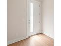 Bright entryway with white door with glass insert, light wood floors, and neutral walls at 312 Ferebee Pl # Brx0023, Charlotte, NC 28213