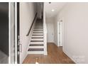 Bright entryway with hardwood floors, a staircase, and white walls leading into the home at 312 Ferebee Pl # Brx0023, Charlotte, NC 28213
