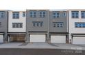 View of the townhome garages, showcasing the multiple attached garages with white doors at 312 Ferebee Pl # Brx0023, Charlotte, NC 28213