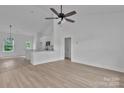 Open concept living room featuring modern ceiling fan, and beautiful wood-look flooring at 6133 Long Branch Rd, Salisbury, NC 28147