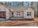 Exterior view of a home under construction, featuring white-framed windows and a covered front porch at 6155 Long Branch Rd, Salisbury, NC 28147
